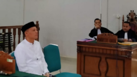 Sabar AS duduk di kursi terdakwa di PN Lubuk Sikaping, Jumat 13 Desember 2024. atas tuduhan berkampanye di tempat ibadah. instagram@sumberkita.id