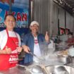 Ahian (kiri) di depan tungku masaknya. Ia harus meracik sendiri menu untuk menjaga kualitas. (Foto: KREDONEWS.COM/ Khristina A Kencana Kheng)