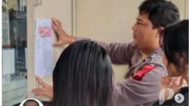 Seorang personel Polresta Pemalang, Jawa Tengah, sedang menempelkan selebaran DPO (Daftar Pencarian Orang) terhadap Haru Masiku, yang sudah 4 tahun burong. istagram@pemalang_updtae