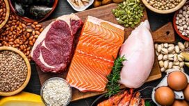 Overhead view of a large group of food with high content of healthy proteins. The composition includes salmon beef fillet, chicken breast, eggs, yogurt, mussels, chick peas, pistachios, cheese, brown lentild, beans, shrimps, canned tuna, pumpkin seeds, soybeans among others. High resolution 42Mp studio digital capture taken with SONY A7rII and Zeiss Batis 40mm F2.0 CF lens