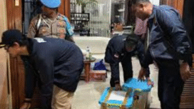 Petugas Bareskrim Polri membawa box plastik diduga wadah emas sitaan yang ditemukan di rumah TW, pemilik toko emas Semar, di Nganjuk. Foto: keuanganews.co