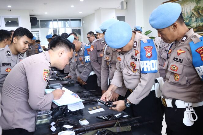 
					Foto:Istimewa
Petugas tengah melakukan pemeriksaan terhadap senpi anggota